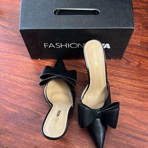 Black pointed toe pumps with bow detail